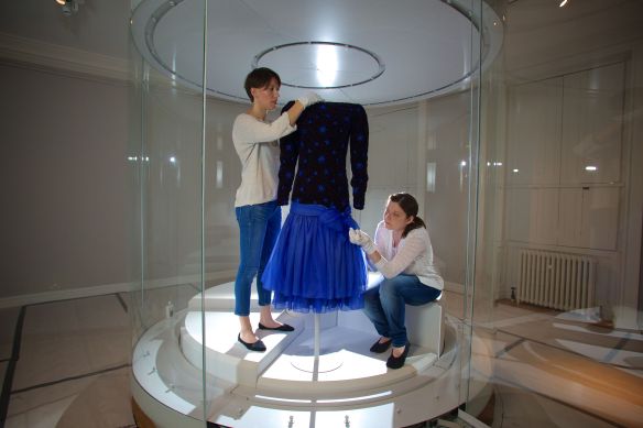 Conservators put the finishing touches to a Dance dress by Jacques Azagury 1985 as worn by Diana, Princess of Wales.